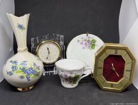Group shot of both Seiko clocks, bud vase, teacup and saucer