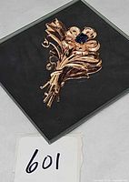 Full view of brooch on dark background showing overall design and size reference number