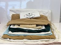 Stacked dust bags in assorted colours showing size variety