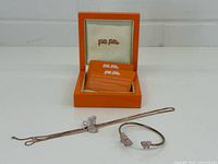 Set showing necklace, bracelet and branded box