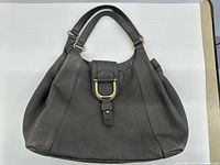 Front view of grey pebbled leather Gucci Greenwich shoulder bag showing horsebit clasp and overall shape
