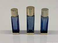 Front view of three cobalt blue perfume bottles