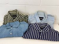 All four folded shirts set out on table