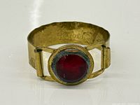 Front view showing bracelet, red cabochon, overall design