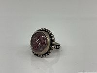 Front view of sterling silver ring with pale purple amethyst cabochon and beaded edging