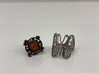 Front view of both rings showing amber stone and butterfly design