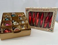Two boxes of vintage glass ornaments, one with red icicles and one with assorted shapes