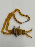 Full view of necklace showing bead arrangement and metal centerpiece