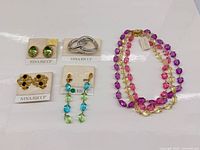 All five Nina Ricci jewelry items laid out on cards