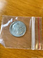 Obverse of 1979 Susan B. Anthony dollar in plastic sleeve