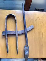 Wooden log scriber and iron bar full view