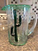 Front view showing cactus motif and spout