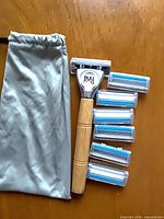 Full view of razor handle, six cartridges, pouch