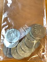 Ten coins in clear plastic bag