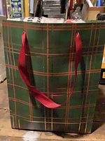 Green plaid gift bag with red ribbon handles
