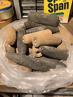 Pile of dark and tan wooden floats in plastic bag