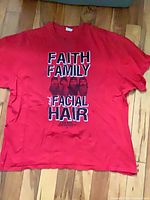 Full view of red Duck Dynasty T-shirt laid flat