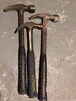 Three Estwing hammers full view on floor