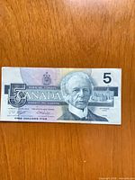 Obverse of the $5 note showing portrait of Sir Wilfrid Laurier, denomination and serial