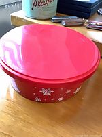 Red round tin container with snowflake pattern