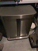 Front view of stainless dual compartment step can showing pedal and lid