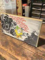 Front view of plaque showing full quote, illustration and cartoon character