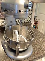 Silver KitchenAid mixer with bowl, whip and beater