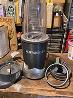 Overall view of NutriBullet base with tall cup, blade assembly and two lip rings