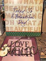 All three metal decor signs grouped together