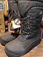 Full view of both black Aleader winter boots with tags attached