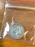 Reverse showing caribou and date 1943