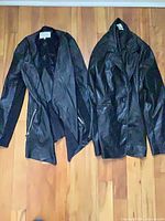 Front view of both jackets side by side on floor