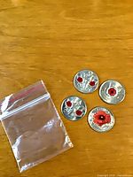 Four colour poppy quarters beside resealable bag