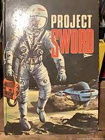 Front dust jacket with astronaut and Project Sword title