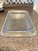 Two stacked rectangular glass dishes