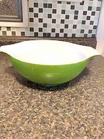 Side view showing green exterior and white interior of Pyrex bowl