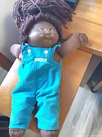 Full view of Cabbage Patch Kids doll lying on table