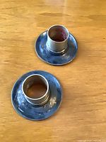 Top view of both candlestick holders showing round bases and sockets