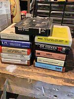 Stacked 8-track tapes showing all cartridge labels