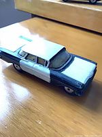 Front-side view of black and white Corgi Chevrolet Impala diecast car