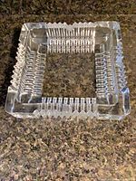 Top view showing entire square clear glass ashtray