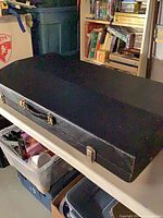 Closed black carry case on shelf