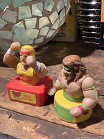 Both WWF figures side by side on wooden surface