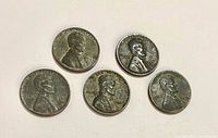 Obverse of five 1943 steel pennies showing Lincoln portrait and date