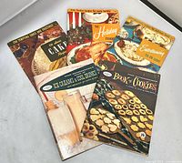 All five vintage recipe pamphlets fanned out