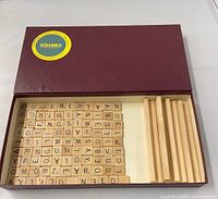 Open box showing wooden tiles and racks