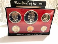 Front view of proof set in holder showing six coins and stand