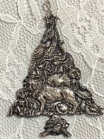 Front of silver-tone animal Christmas tree ornament
