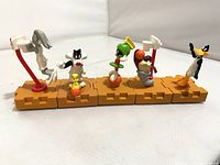 Six figures lined up on interlocking bases