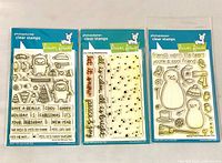 Three Lawn Fawn stamp sets side by side